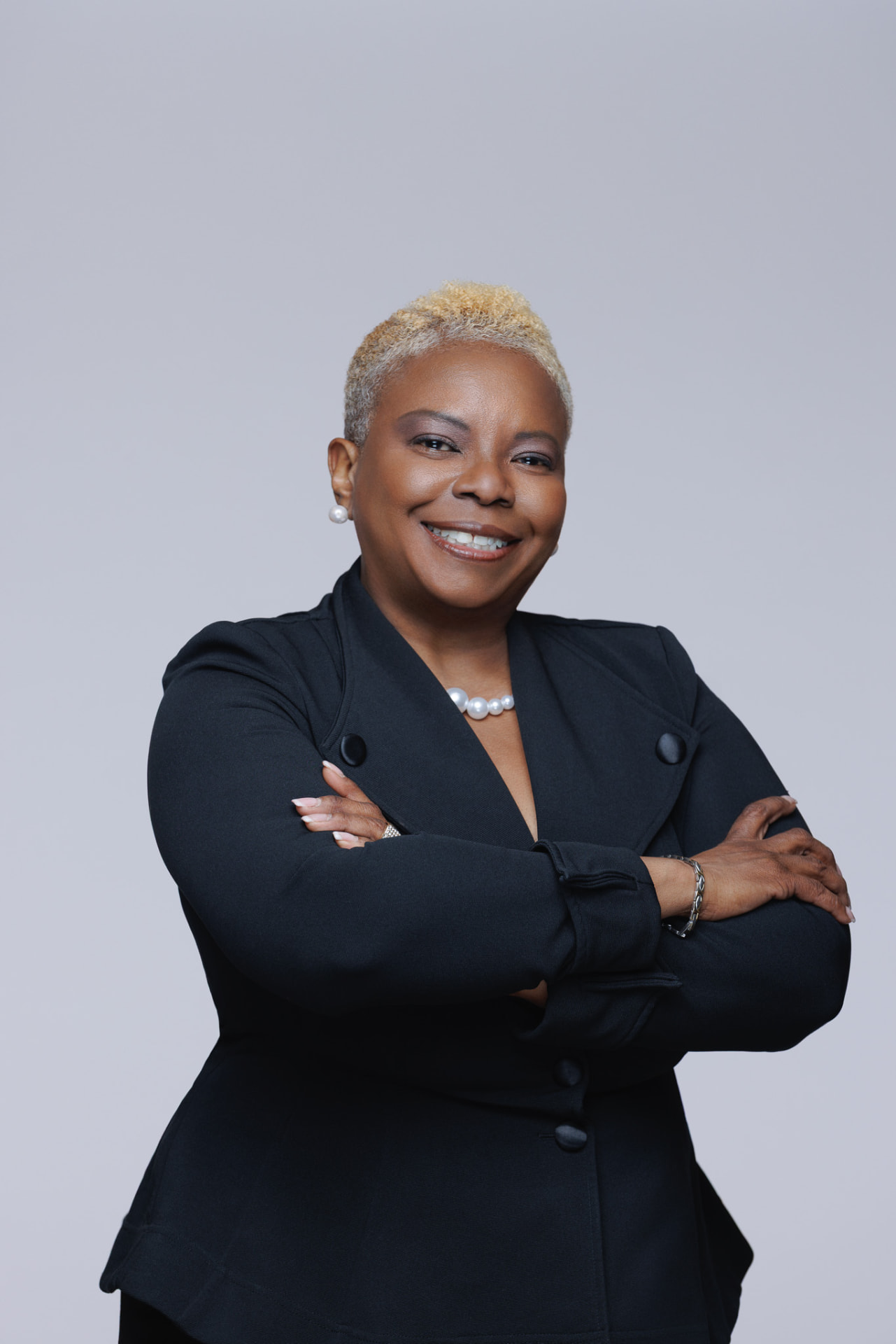 Robben Washington smiling with her arms folded